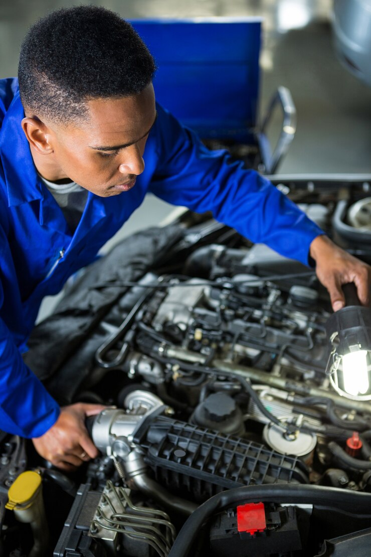 mechanic-examining-car_1170-1686